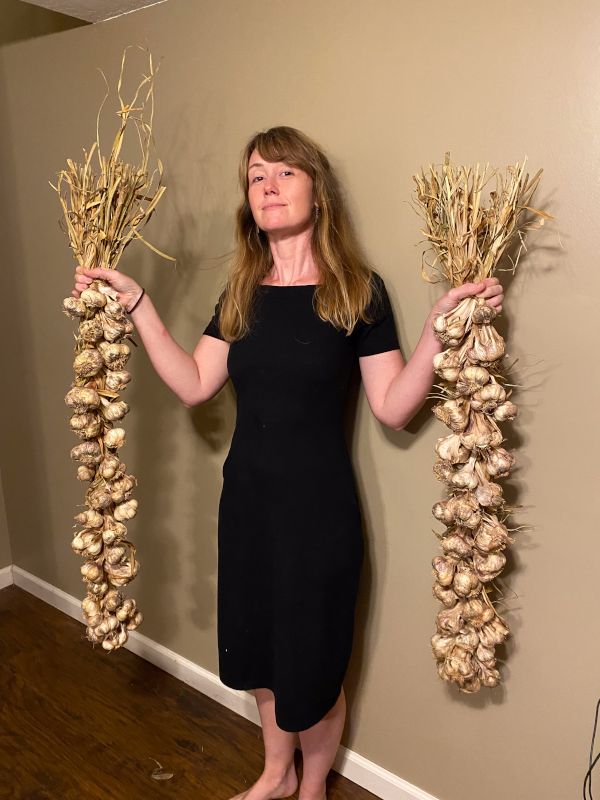 Savanna Proudly Showing Off Her Garlic Harvest